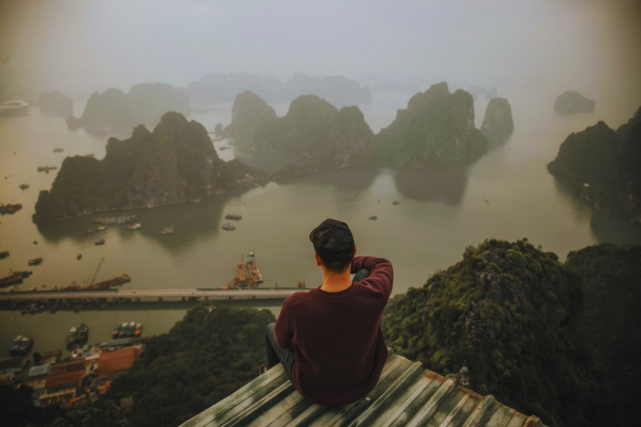 Solo travel Vietnam overlooking Ha Long Bay limestone islands